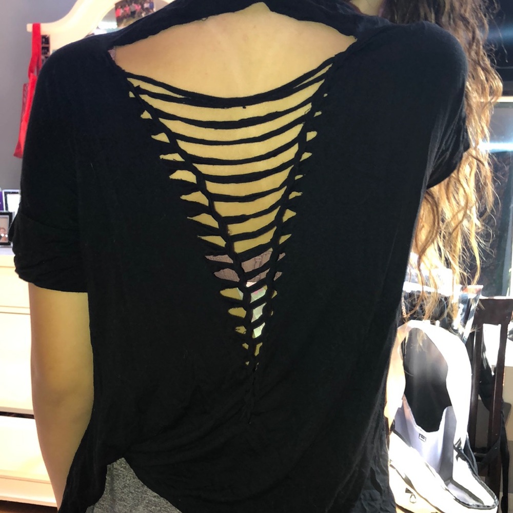 a black tshirt with rips in the back